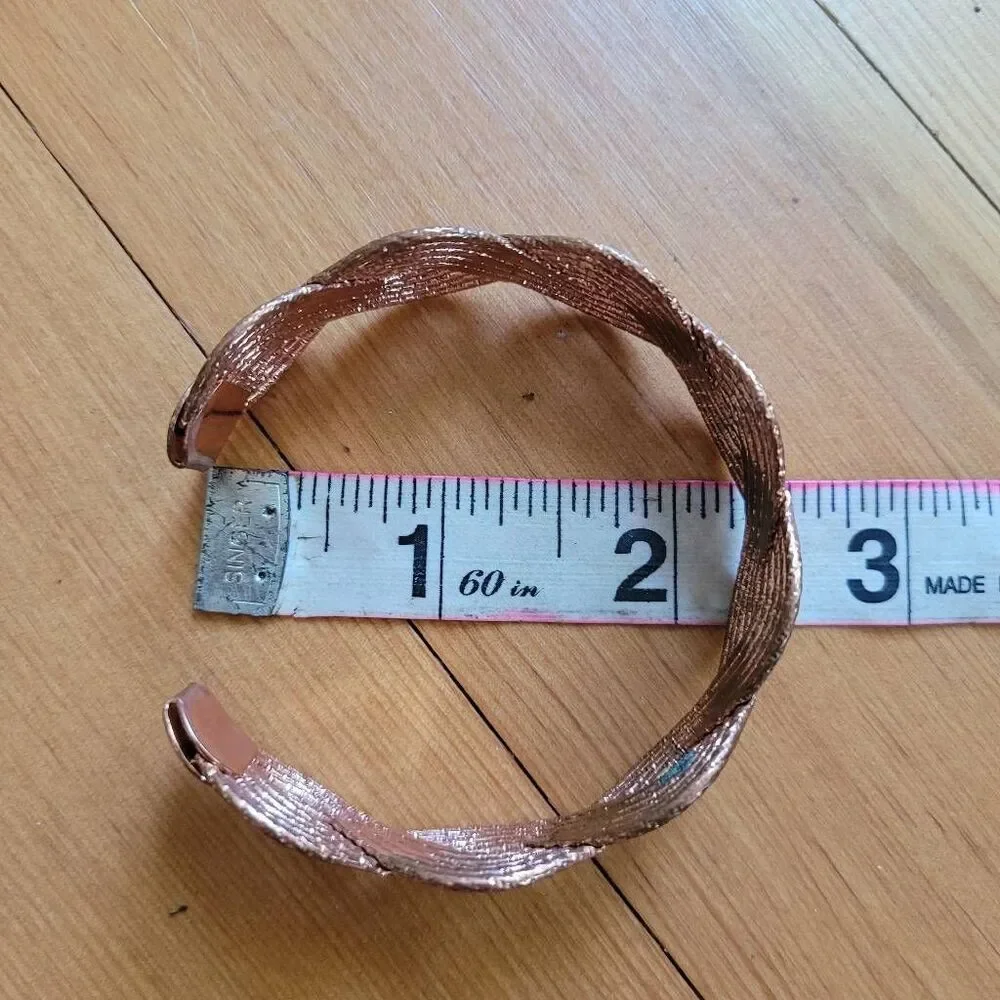 Set of two bracelets copper colored wavy bangle and stretchy beaded multicolored